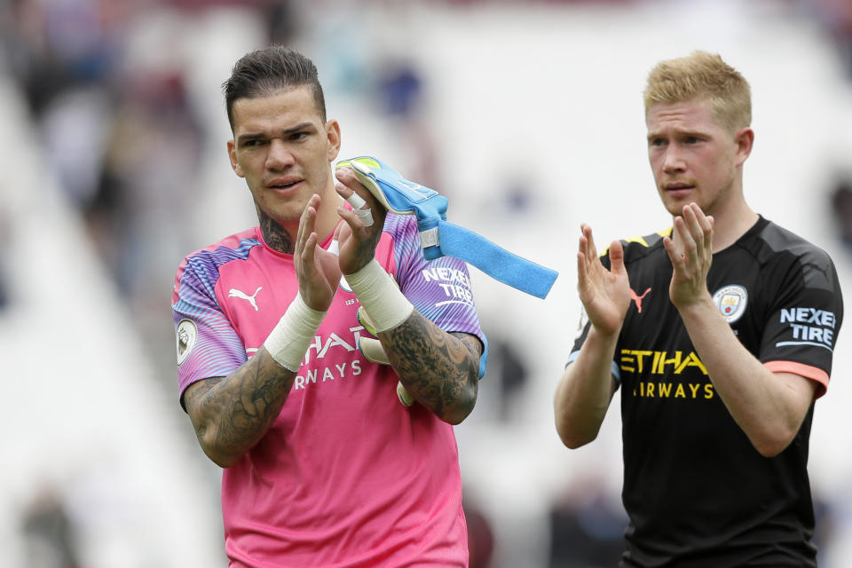 Manchester City's goalkeeper Ederson and Kevin De Bruyne, right, applaud at the end of the English Premier League soccer match between West Ham United and Manchester City at London stadium in London, Saturday, Aug. 10, 2019. Manchester City won 5-0 (AP Photo/Kirsty Wigglesworth)