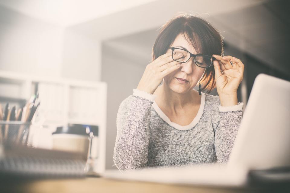 tired woman at work desk