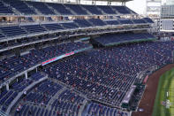 Fans sit socially distanced in the stands during an opening day baseball game between the Atlanta Braves and the Washington Nationals at Nationals Park, Tuesday, April 6, 2021, in Washington. (AP Photo/Alex Brandon)