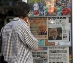 A man reads the front pages of various newspapers announcing Portugal's central bank's decision to rescue troubled lender Banco Espirito Santo (BES) in a 4.9 billion euro ($6.6 billion) recapitalisation in Lisbon in this August 4, 2014 file photo. REUTERS/Hugo Correia/Files