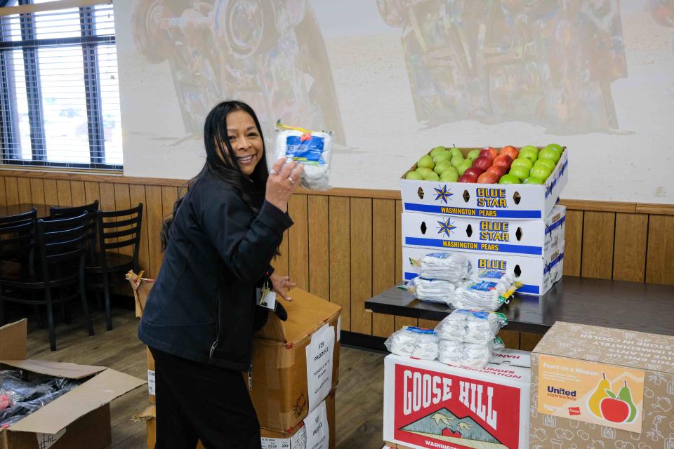 Wendy Lara, community development coordinator for the Salvation Army of Amarillo, loads a box with socks Tuesday at a United Supermarkets location in Amarillo.