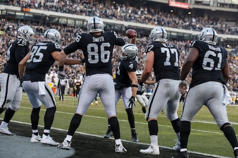 Quarterback Derek Carr #4 of the Oakland Raiders celebrates with tight end Lee Smith #86 after after a touchdown against the Pittsburgh Steelers during the fourth quarter at O.co Coliseum - Credit: Jason O. Watson/Getty Images