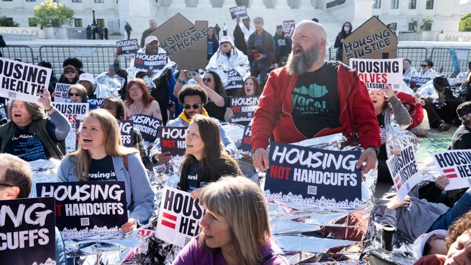 PHOTO: Demonstrators hold signs and use reflective blankets during a protest outside the Supreme Court in Washington, Apr. 22, 2024. (Saul Loeb/AFP via Getty Images)