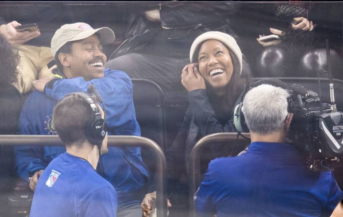 Regina and Ian laughing at a sporting event