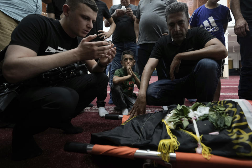 Mourners gather around the body of 15-year-old Palestinian Sadeel Naghniyeh during her funeral in the West Bank Jenin refugee camp, Wednesday, June 21, 2023, Naghniyeh died from wounds sustained in an Israeli military raid on Monday that triggered some of the fiercest fighting with Palestinian militants in years. (AP Photo/Majdi Mohammed)
