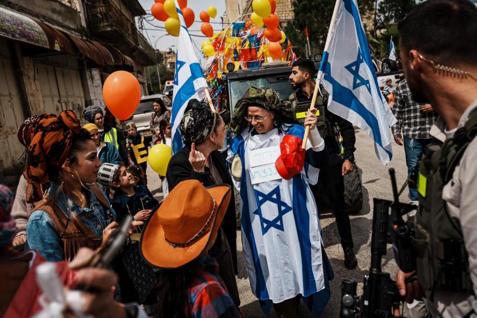 Orit Strook, center, Knesset member and the minister of settlements and national missions, is greeted by Israeli settlers.