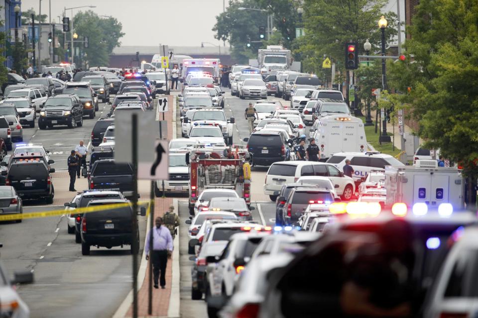 Police respond to reports of a shooting and subsequent lockdown at the U.S. Navy Yard in Washington July 2, 2015. Armed security personnel keep a watchful eye as police respond to reports of a shooting and subsequent lockdown at the U.S. Navy Yard in Washington July 2, 2015. (REUTERS/Jonathan Ernst)