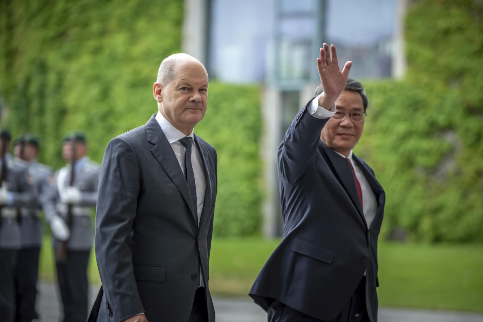 Chinese Premier Li Qiang, right, greets as he arrives to meet German Chancellor Olaf Scholz, left, in front of the Federal Chancellery before the reception with military honors for the German-Chinese government consultations, in Berlin, Germany, Tuesday June 20, 2023. (Michael Kappeler/dpa via AP)