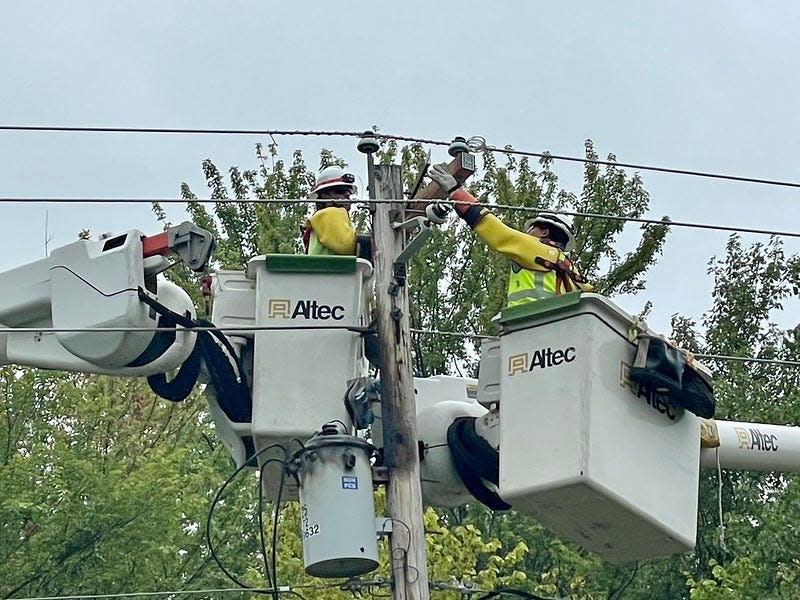 Utility workers make repairs to electric lines in Streetsboro after a storm resulted in thousands losing power last week in Portage County.