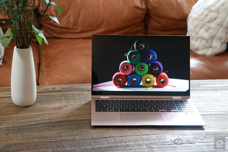 <p>Samsung Galaxy Book Pro 360 review pictures. Front view of the 15-inch Galaxy Book Pro 360 on a table in front of a brown couch.</p> 