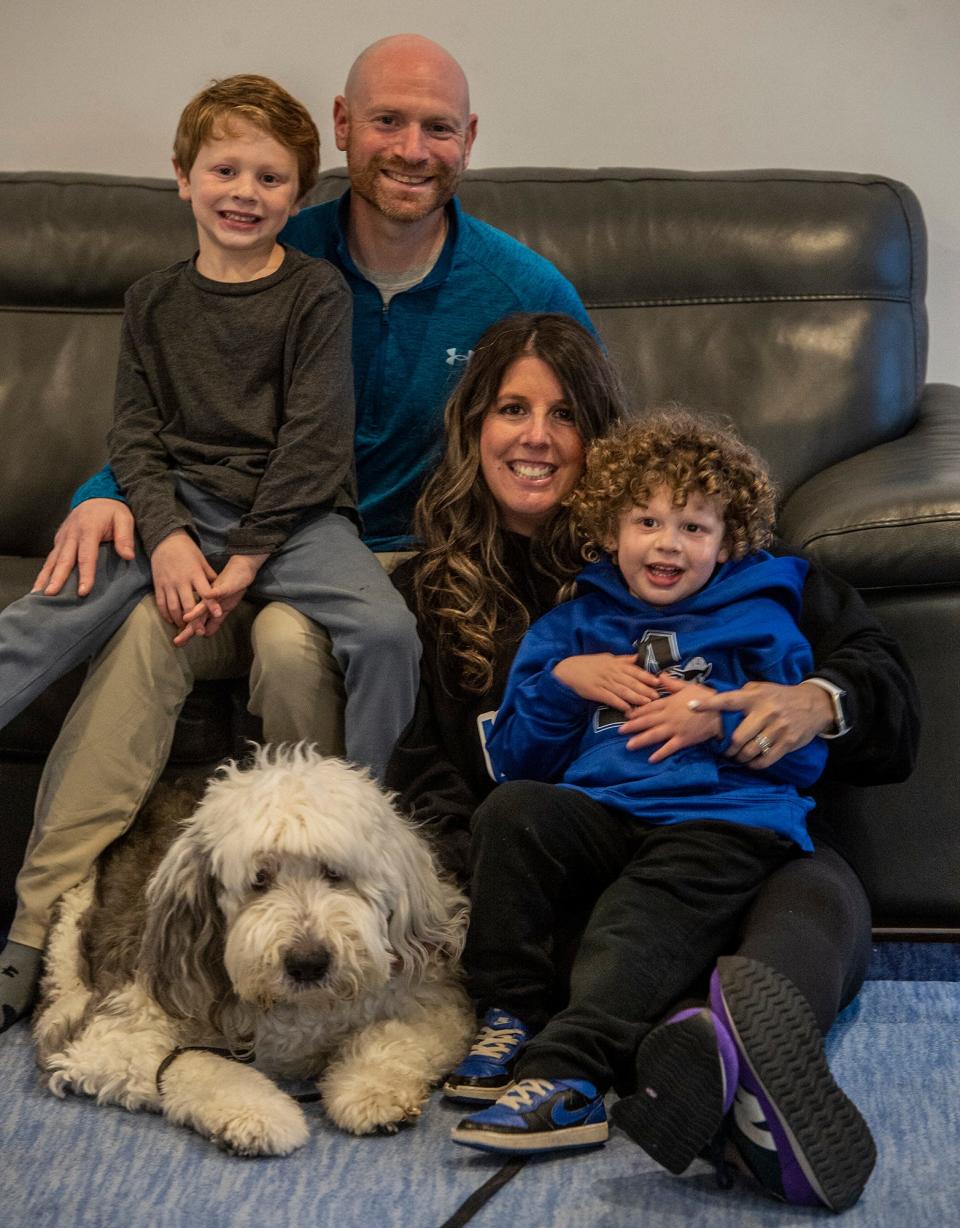 The Marks family in Ashland, Jan. 11, 2024. From left, Logan, 6, Stephen, Jamie, Lincoln, 5, and their dog, Stanley. Stephen Marks, the former AD at Ashland High, and his wife Jamie have started Linclusion, named after their autistic, non-verbal son Lincoln, 5. Linclusion helps send children to summer camp with an aid so those kids can be part of the camp with other children. Linclusion helps raise money to pay for the aids. Linclusion has already partnered with Pilgrim Day Camp in Framingham and Ashland Rec Center. Linclusion.org is their website.