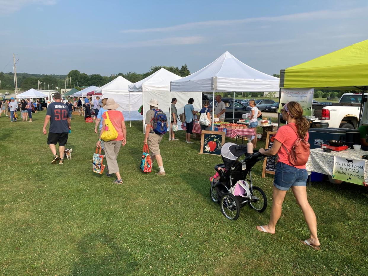 Shoppers roam the grounds of the Granville Farmer's Market early on Aug. 7, 2021.