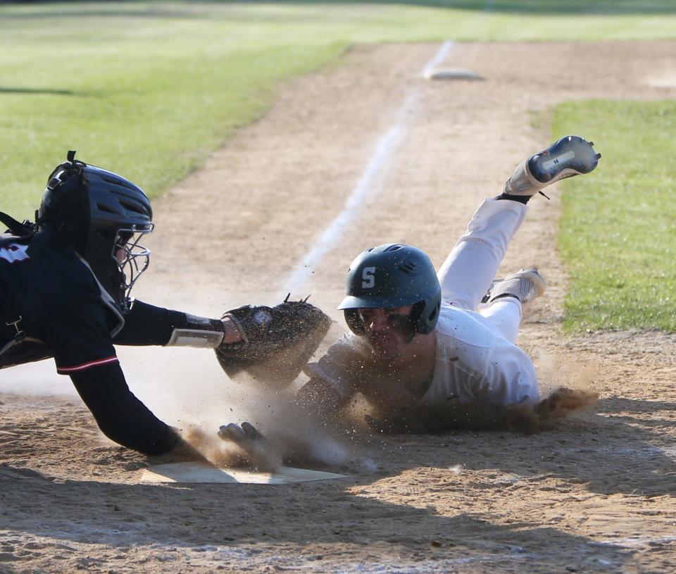 Spackenkill's Carter Usher slides into home under Dover's Declan Noonan during Friday's game on April 29, 2022.