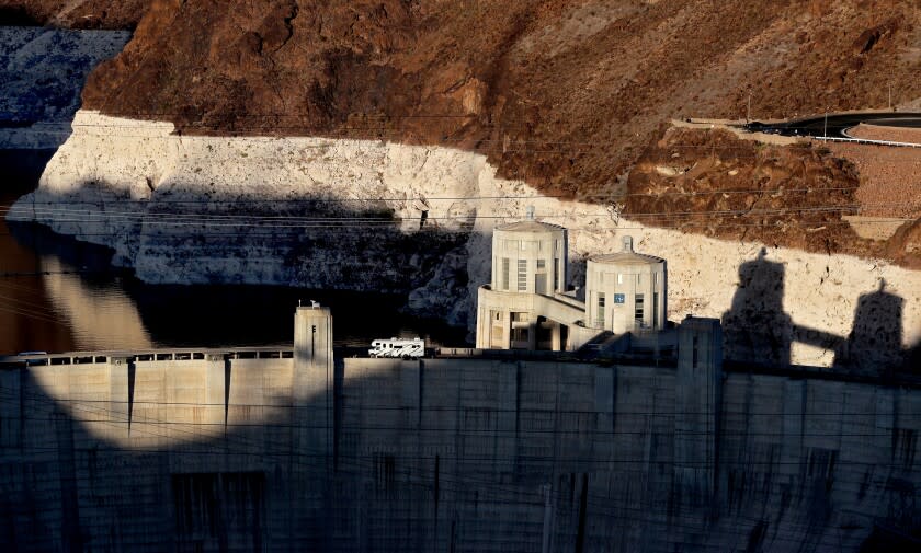 LAKE MEAD, NEV. - JUNE 11, 2021. A motorhome travels across the Hoover Dam near Boulder City, Nev. A white "bathtub ring" above the dam hows how far below capacity Lake Mead - the nation's largest reservoir - currently is. Water levels at Lake Mead have hit their lowest points in history amid an ongoing megadrought, creating uncertainty about the water supply for millions of people in the western United States. (Luis Sinco / Los Angeles Times)