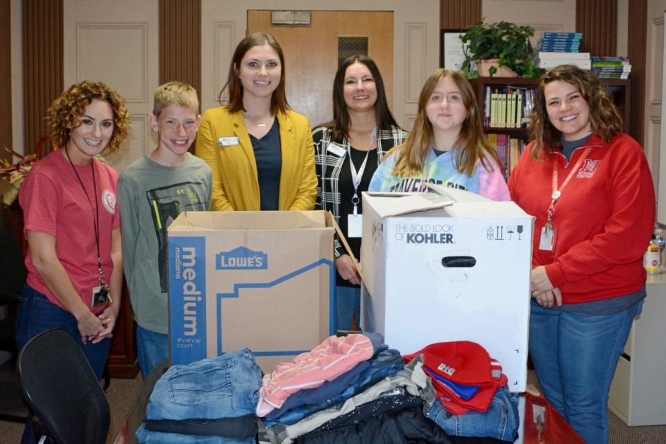 Monroe Community Credit Union recently held a winter clothing drive which benefitted Monroe Middle School. Standing with some of the donations are (from left) Jackie Lenderman, MMS assistant principal; Quinten Kaczmarek, student board of delegates; April Eggert, MCCU marketing specialist; Jen Langenderfer, MCCU vice president of member experience; Ashlynn Jensen, student board of delegates; and Sara Staten, MMS principal.