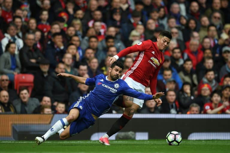 Chelsea's striker Diego Costa (L) vies with Manchester United's defender Marcos Rojo during the English Premier League football match between Manchester United and Chelsea on April 16, 2017