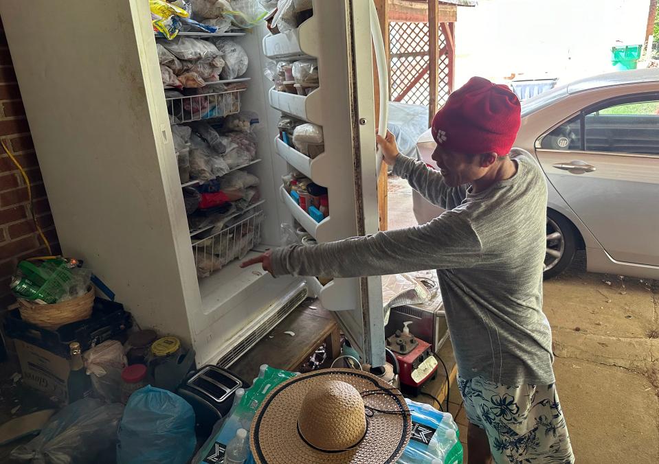 Saing Chhoeun, 54, shows the contents of the refrigerator he took cover behind during an incident April 29, 2024, in Charlotte, N.C., where four law enforcement officers, including three on a U.S. Marshals Task Force, were killed and four other officers were injured after being shot while attempting to serve a warrant.