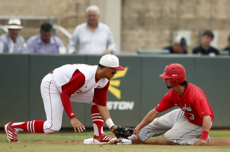 Joe Dunand (left) looks like his uncle A-Rod while making the tag at third base. (AP Photo)