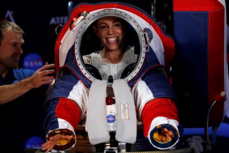 Advanced Space Suit Engineer at NASA Kristine Davis gets into the xEMU prototype space suit for the next astronaut to the moon by 2024, during its presentation at NASA headquarters in Washington