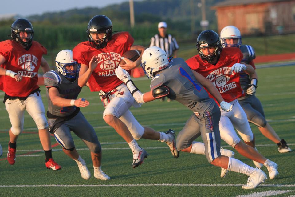 Fairfield Union's Hunter Clark attempts to split between Lakewood's Adam Crawford and Ethan Romine (1) during a scrimmage at Calhoun Memorial Field on Thursday, Aug. 10, 2023.