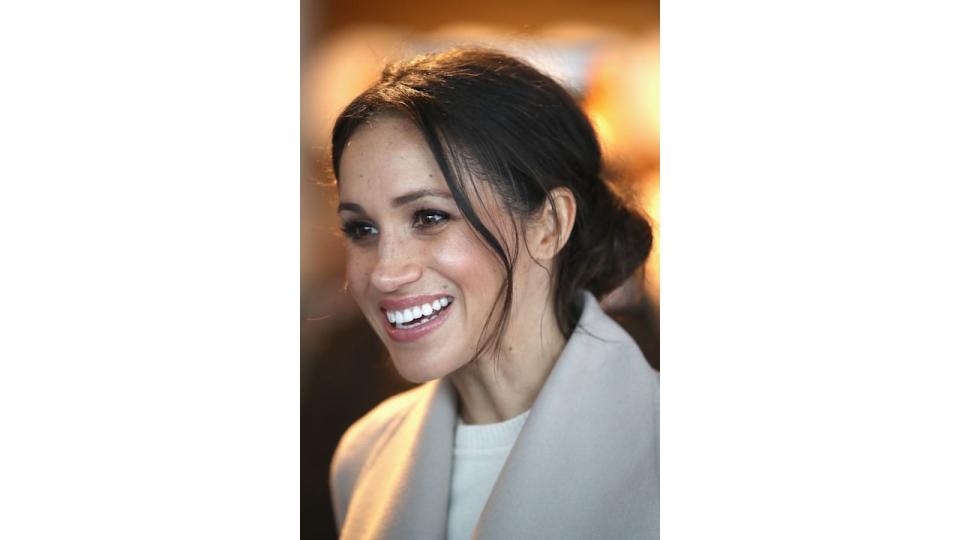 Meghan Markle smiling with messy hair