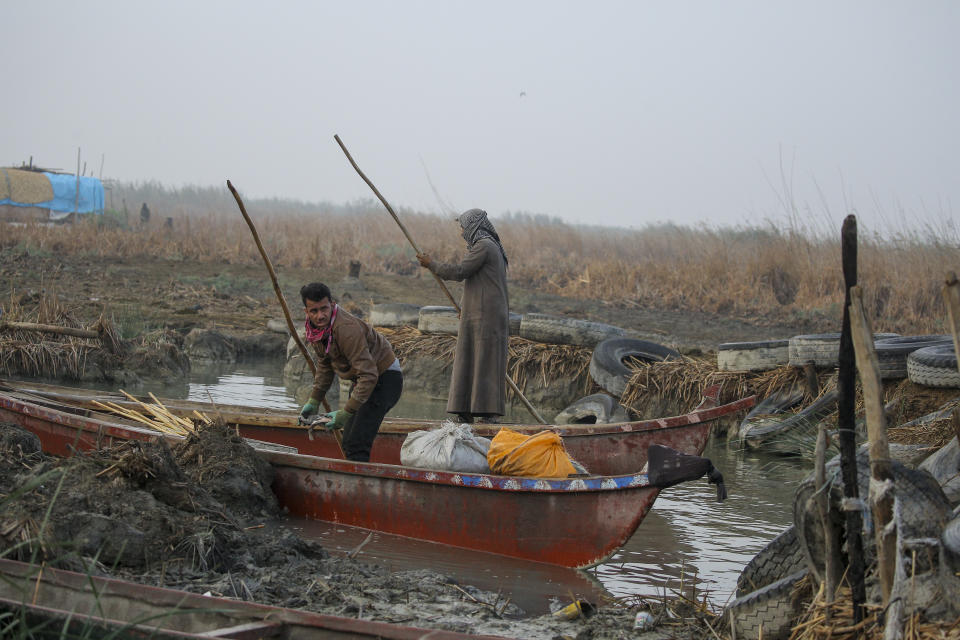 Fishermen prepare to head out into the Chibayish marshes of southern Iraq, in Dhi Qar province, Iraq, Saturday, Nov. 19, 2022. (AP Photo Anmar Khalil)