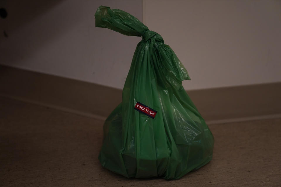 A "COVID Patient" sticker is placed on a bag containing some belongings of a deceased COVID-19 patient at Providence Holy Cross Medical Center in the Mission Hills section of Los Angeles on Saturday, Jan. 9, 2021. (AP Photo/Jae C. Hong)