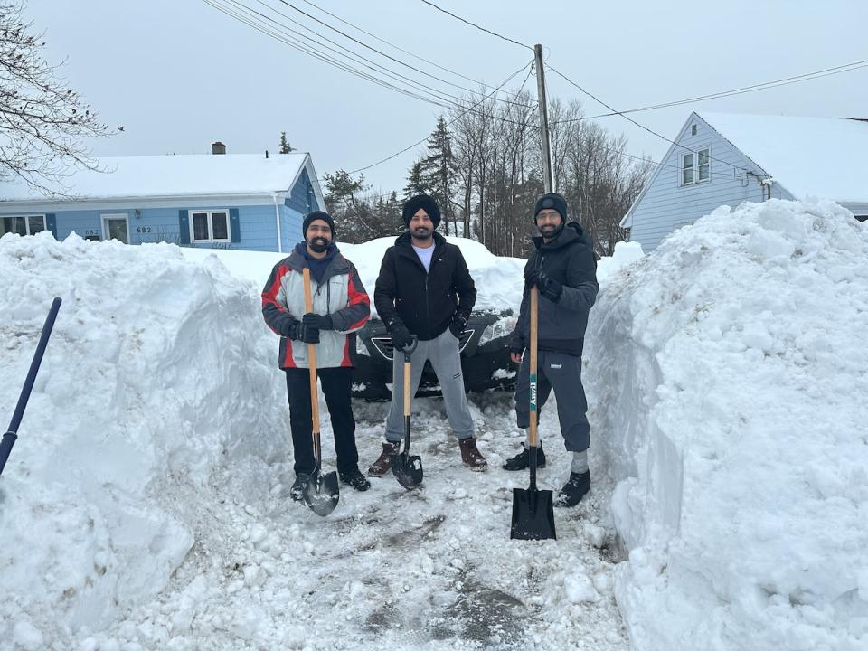 A group of shovellers work to clear their driveway in in Sydney, Nova Scotia. In February 2024, Atlantic Canada received their first big snowstorm of the year later than normal, which ended up being the biggest snowstorm in two decades. Under climate change, extreme storms are more likely. 