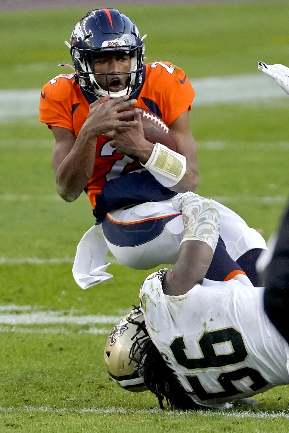 Denver Broncos quarterback Kendall Hinton (2) is tackled by New Orleans Saints outside linebacker Demario Davis (56) during the second half of an NFL football game, Sunday, Nov. 29, 2020, in Denver. (AP Photo/Jack Dempsey)