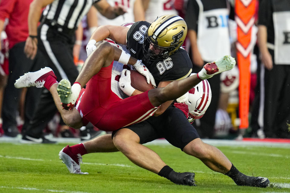 Wisconsin cornerback Jason Maitre (23) tackles Purdue tight end Max Klare (86) after a catch during the first half of an NCAA college football game in West Lafayette, Ind., Friday, Sept. 22, 2023. (AP Photo/Michael Conroy)