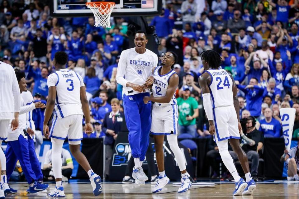 Antonio Reeves, right, celebrates with Ugonna Onyenso, center, after a basket against the Providence Friars in the first round of this year’s NCAA Tournament.