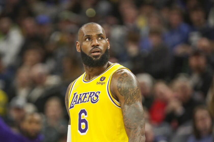 Los Angeles Lakers forward LeBron James looks on during an NBA basketball game.