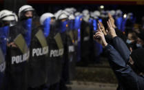 A police cordon guards the house of Poland's ruling conservative party leader Jaroslaw Kaczynski against a crowd protesting a decision by the Constitutional Court, in Warsaw, Poland, on Friday, Oct. 23, 2020. Poland’s top court ruled Thursday that a law allowing abortion of fetuses with congenital defects is unconstitutional, shutting a major loophole in the predominantly Catholic country's abortion laws that are among the strictest in Europe. Defying the pandemic-related ban on gatherings, the protesters chanted for the government to resign. (AP Photo/Czarek Sokolowski)