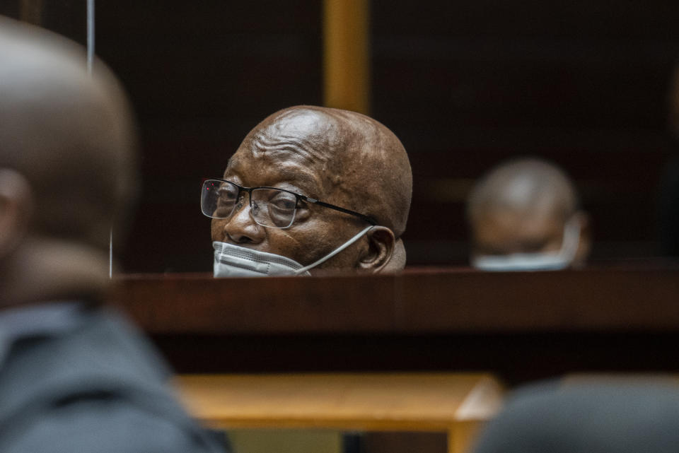 Former South African President Jacob Zuma, sits in the High Court in Pietermaritzburg, South Africa, Tuesday Oct. 26, 2021. Zuma has demanded to be acquitted of corruption charges because of the alleged abuse he has suffered at the hands of his prosecutors. He is in court facing charges of corruption, money laundering and racketeering. (AP Photo/Jerome Delay, Pool)