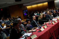 Staffers look on ahead of the vote on the repeal of so called net neutrality rules at the Federal Communications Commission in Washington, U.S., December 14, 2017. REUTERS/Aaron P. Bernstein