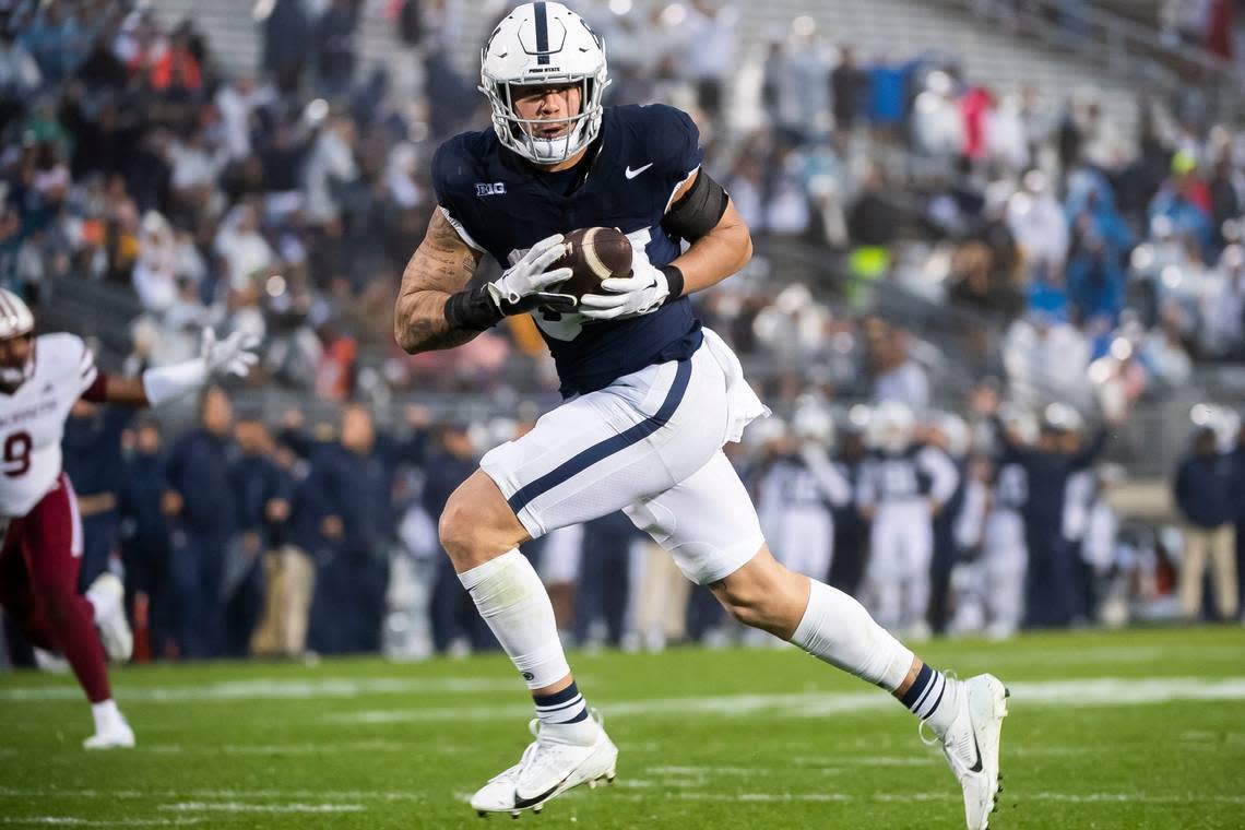 Penn State tight end Theo Johnson (84) goes 30 yards to score a touchdown during the second half of a NCAA football game against Massachusetts Saturday, Oct. 14, 2023, in State College, Pa. The Nittany Lions won, 63-0.