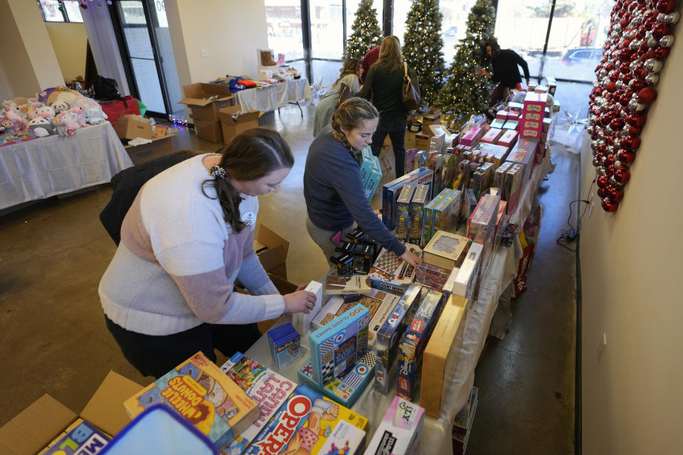 Workers arrange toys at The Toy Store, a free-referral based toy store Thursday, Dec. 7, 2023, in Nashville, Tenn. The facility is co-founded by Brad Paisley and Kimberly Williams-Paisley. The couple also started The Store, a free-referral based grocery store they opened in partnership with Belmont University in March 2020. (AP Photo/Mark Humphrey)