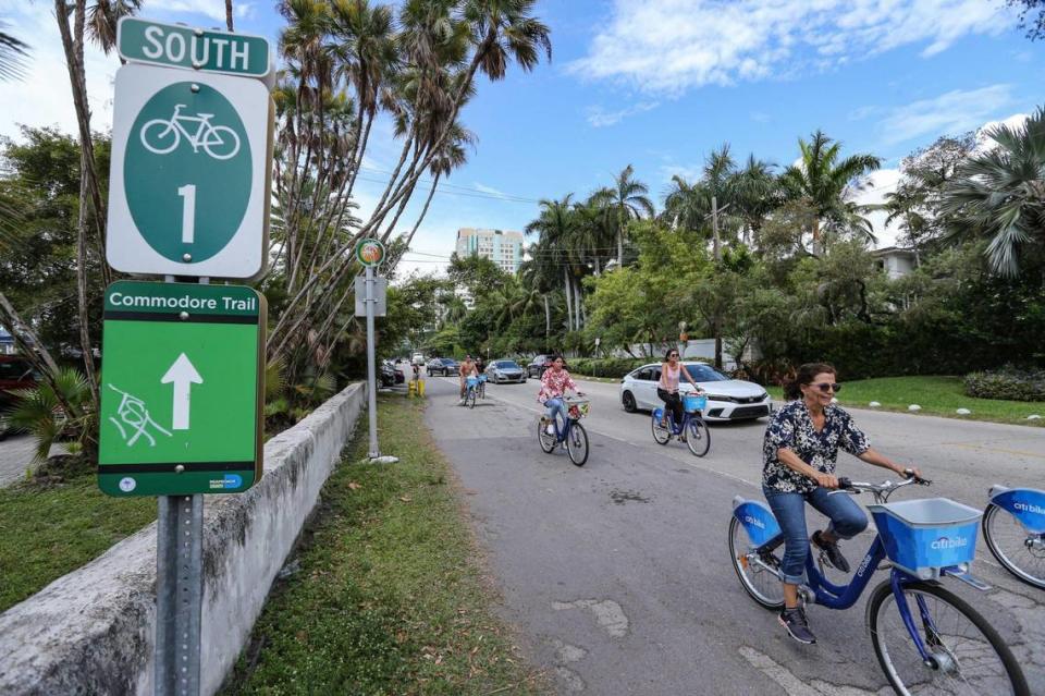 Cyclists on CitiBikes rode on the Commodore Trail along Kennedy Park on South Bayshore Drive in Miami’s Coconut Grove in 2022. Miami-Dade County is working on a $16 million plan to rebuild Bayshore and the fraying trail. Cracked and buckled pavement, narrow segments, poor markings and speeding traffic put trail users in danger, critics say.