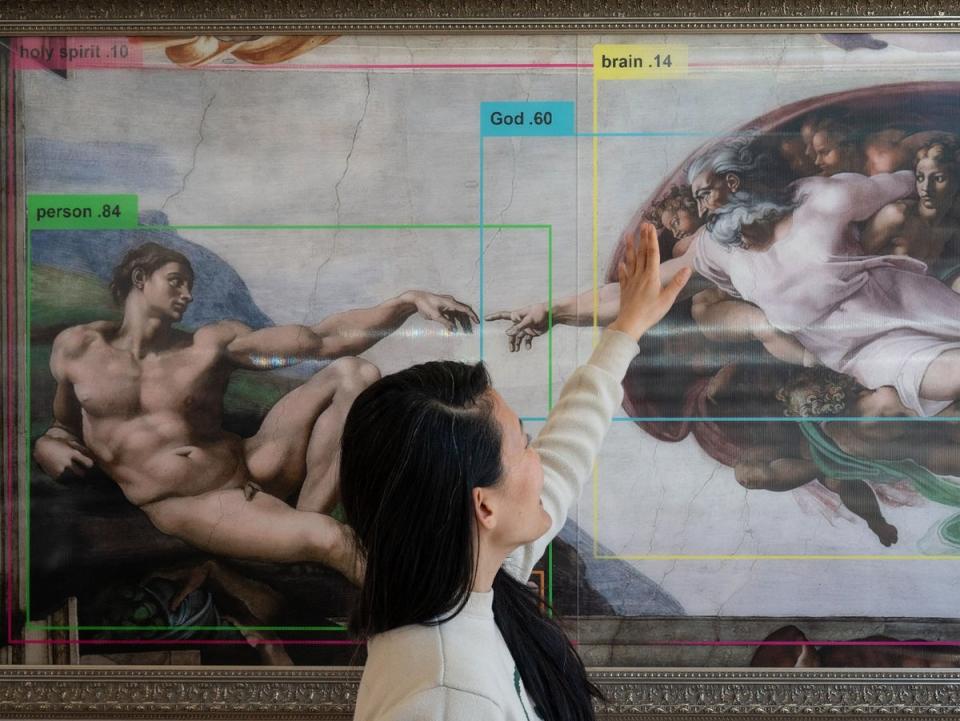 An artist stands in front of an artwork at an exhibition in San Francisco on 9 March, 2023, aimed at helping visitors think about the potential dangers of artificial intelligence (Getty Images)