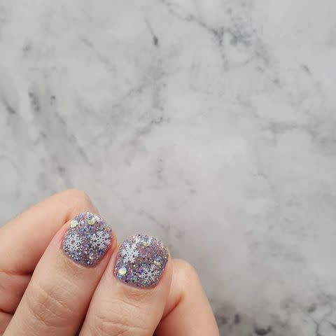 <p>These snowflake thumbnails may look a little intricate, but they're actually just layered-up polishes, glitters, and decals. To recreate, coat your nails with <a href="https://www.amazon.com/ZOYA-Polish-Cosmo-Magical-Pixiedust/dp/B00IVO9KKS/ref=sr_1_5?crid=1A2RSJAY9CH0L&keywords=glitter+nail+polish&qid=1575226238&sprefix=glitter+nail%2Caps%2C398&sr=8-5&tag=syn-yahoo-20&ascsubtag=%5Bartid%7C10049.g.30065321%5Bsrc%7Cyahoo-us" rel="nofollow noopener" target="_blank" data-ylk="slk:silver glitter nail polish;elm:context_link;itc:0;sec:content-canvas" class="link ">silver glitter nail polish</a>, stick on a <a href="https://www.amazon.com/Snowflakes-Sequins-Christmas-Decorations-Manicure/dp/B07JN9HWLZ/ref=asc_df_B07JN9HWLZ/?tag=syn-yahoo-20&linkCode=df0&hvadid=241954354979&hvpos=1o5&hvnetw=g&hvrand=6842359307280671220&hvdev=c&hvlocphy=9004338&hvtargid=pla-592473875497&psc=1&ascsubtag=%5Bartid%7C10049.g.30065321%5Bsrc%7Cyahoo-us" rel="nofollow noopener" target="_blank" data-ylk="slk:few loose snowflakes;elm:context_link;itc:0;sec:content-canvas" class="link ">few loose snowflakes</a>, then dot on <a href="https://www.amazon.com/YGDZ-Rhinestones-Crystals-Flatback-Decorations/dp/B07SJZKYYG/ref=sr_1_2_sspa?keywords=swarovski+nail+crystals&qid=1575226383&sr=8-2-spons&psc=1&spLa=ZW5jcnlwdGVkUXVhbGlmaWVyPUEyT1M0NzBUQkZTNFQ3JmVuY3J5cHRlZElkPUEwOTc4NzM2MzRMOVBZS0g0Nlc5SCZlbmNyeXB0ZWRBZElkPUEwMTYyODk5R1NIQ1QyUVE5NkY3JndpZGdldE5hbWU9c3BfYXRmJmFjdGlvbj1jbGlja1JlZGlyZWN0JmRvTm90TG9nQ2xpY2s9dHJ1ZQ%3D%3D&tag=syn-yahoo-20&ascsubtag=%5Bartid%7C10049.g.30065321%5Bsrc%7Cyahoo-us" rel="nofollow noopener" target="_blank" data-ylk="slk:loose crystals;elm:context_link;itc:0;sec:content-canvas" class="link ">loose crystals</a>. Finish with a <a href="https://www.cosmopolitan.com/style-beauty/beauty/g29548552/best-top-coat-nail-polish/" rel="nofollow noopener" target="_blank" data-ylk="slk:clear top coat;elm:context_link;itc:0;sec:content-canvas" class="link ">clear top coat</a>.</p><p><a href="https://www.instagram.com/p/B5g6uqvlh12/" rel="nofollow noopener" target="_blank" data-ylk="slk:See the original post on Instagram;elm:context_link;itc:0;sec:content-canvas" class="link ">See the original post on Instagram</a></p>