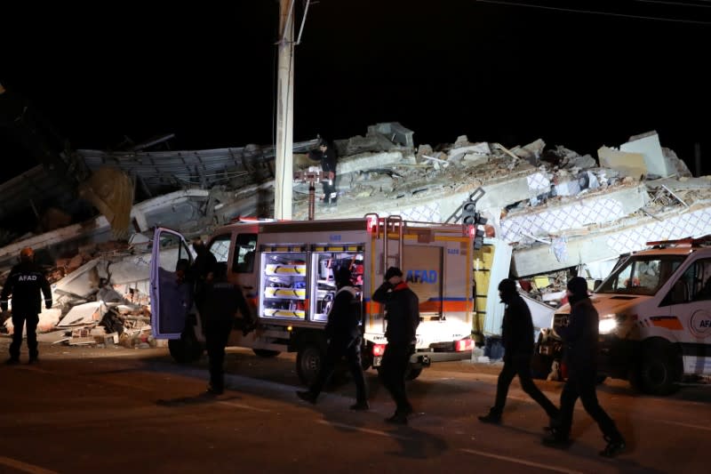 Rescue workers search on a collapsed building after an earthquake in Elazig