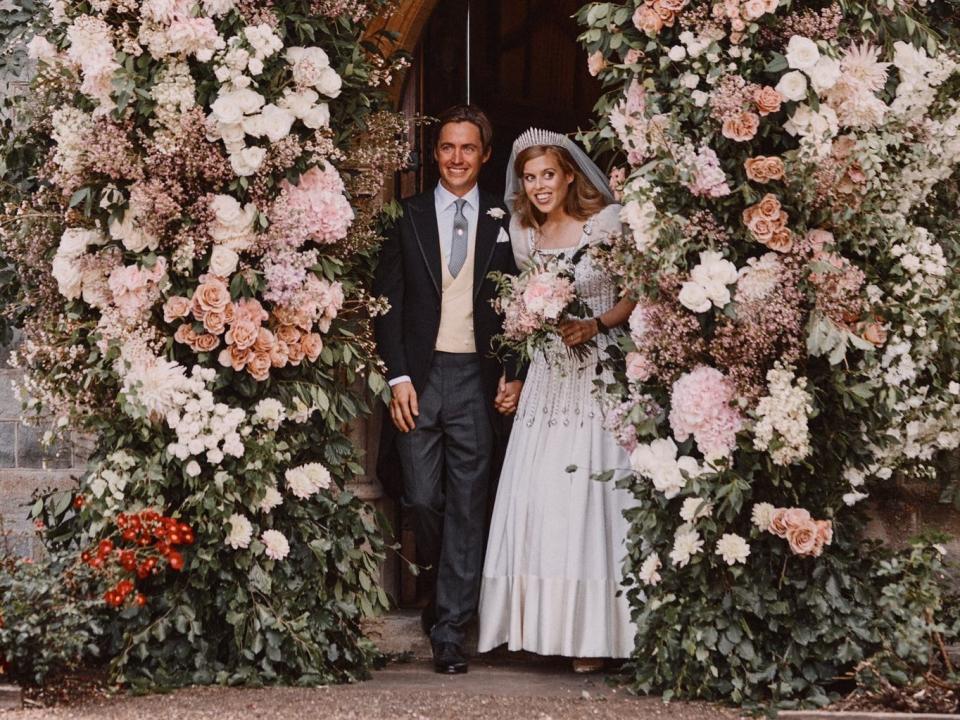 Princess Beatrice and Edoardo Mapelli Mozzi stand under a floral archway after their wedding ceremony in 2020.