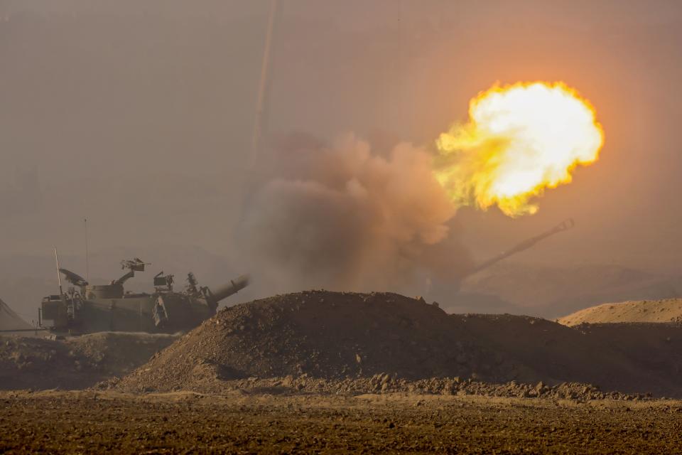 Israel Defense Forces (IDF) soldiers fire a 155 mm howitzer at an undisclosed location near the border with Gaza (EPA)