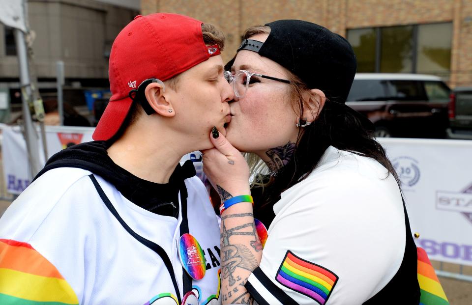 Morgan Webb of Washington, Mo., left, and Marie Lockwood, of Jacksonville, share a kiss during the 2022 PrideFest in Springfield,  Saturday May 21, 2022. [Thomas J. Turney/The State Journal-Register]