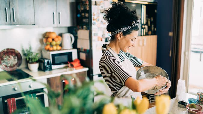 Close-up of a beautiful woman baking muffins.