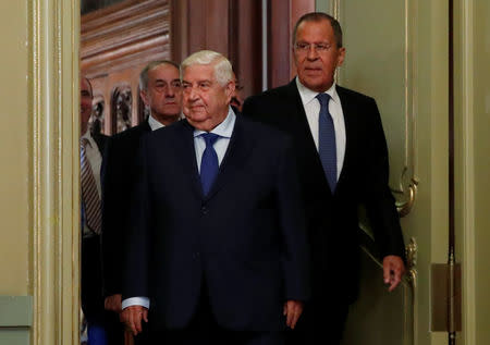 Syrian Foreign Minister Walid al-Moualem and Russian Foreign Minister Sergei Lavrov enter a hall for a joint news conference following their talks in Moscow, Russia August 30, 2018. REUTERS/Maxim Shemetov