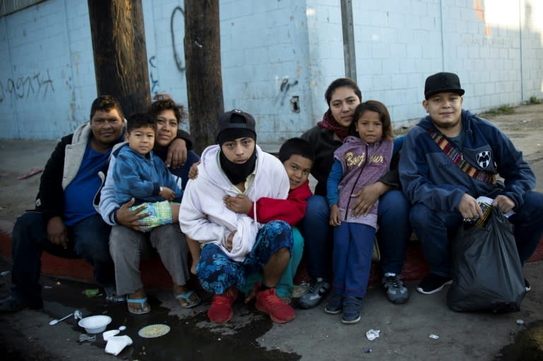 A family from Honduras poses outside a temporary shelter in Tijuana, Mexico