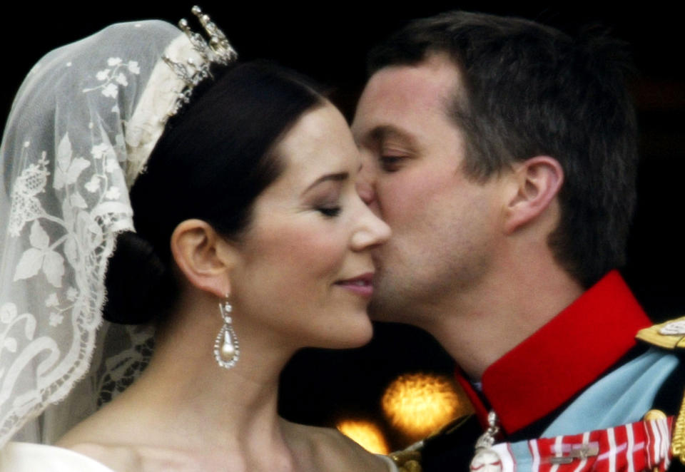 Princess Mary and Crown Prince Frederik of Denmark kiss as the Royal couple appear on the balcony