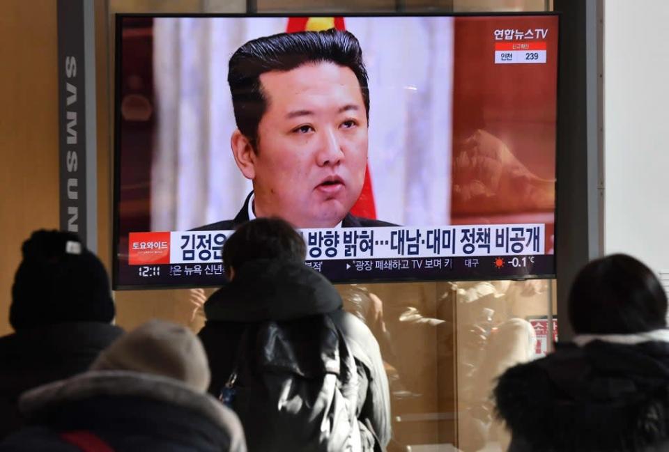 People watch a television news programme showing a picture of North Korean leader Kim Jong-un attending a plenary meeting of the Central Committee of the Workers&#x002019; Party of Korea on 1 January (AFP via Getty Images)