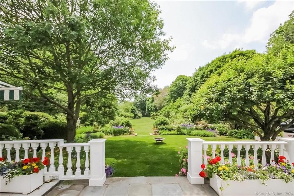 The home is situated on two acres and boasts park-like grounds. Houlihan Lawrence